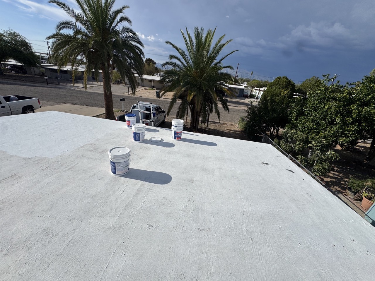 Roof coating materials staged on a Tucson jobsite