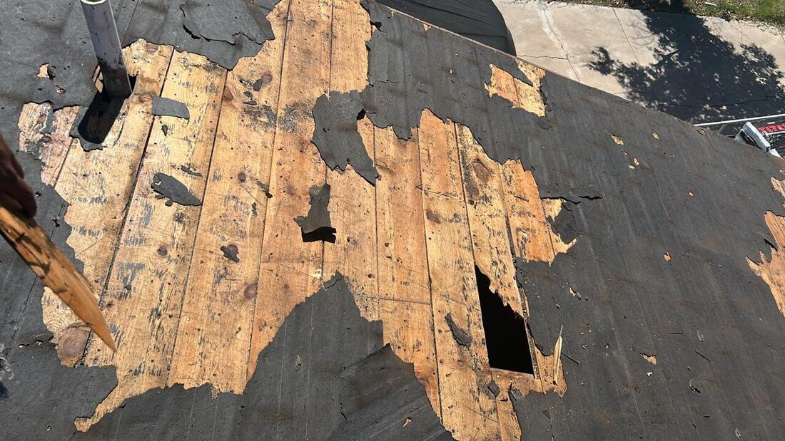 Roof deck damage before repair, wide view